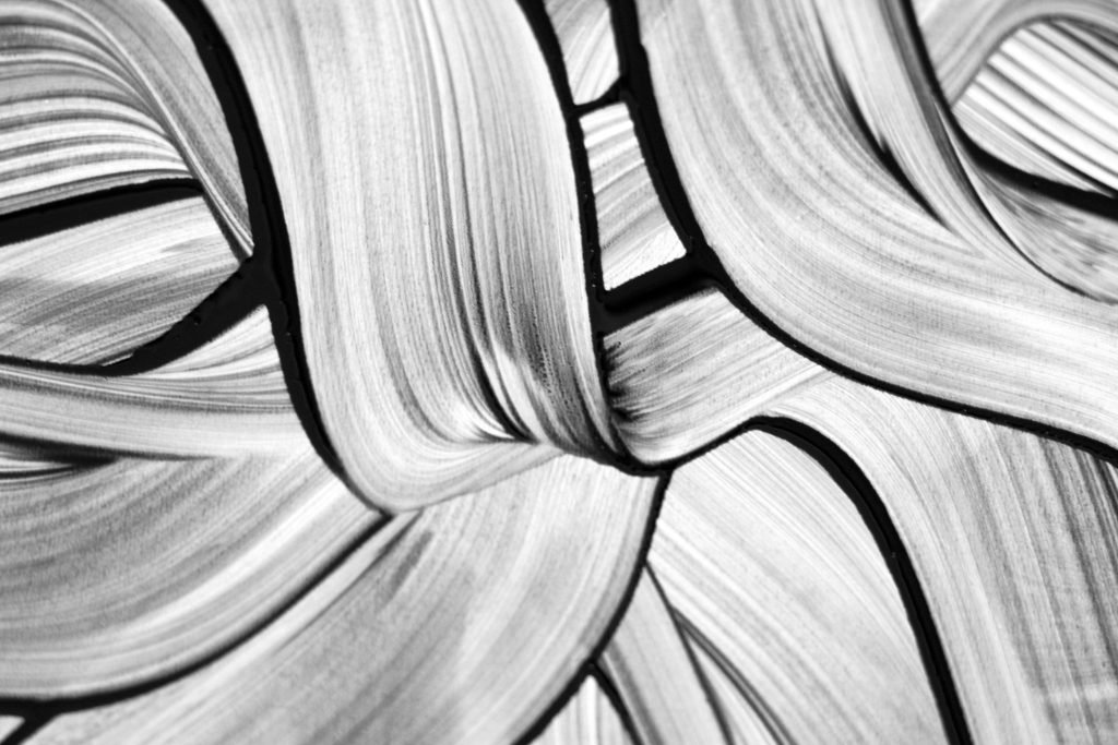 Dynamic black and white abstract brush stroke design, showcasing artistic texture and movement.