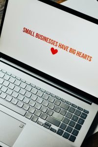 pexels-photo-7661643-7661643 Close-up of laptop displaying 'Small Businesses Have Big Hearts' message with a heart icon.
